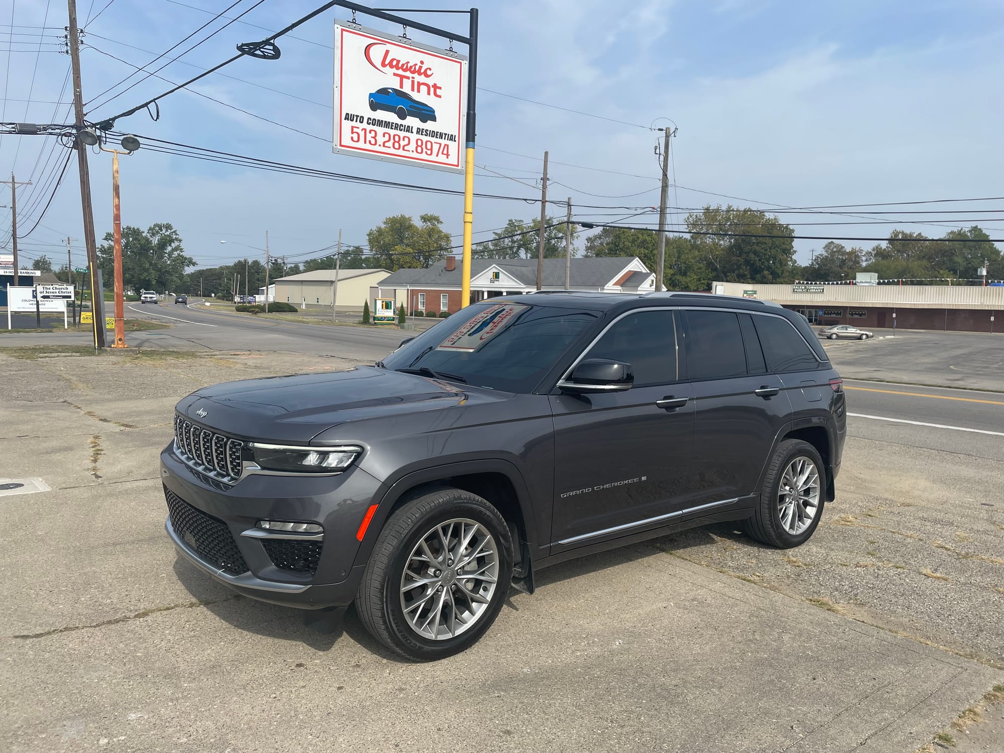 Tinted Jeep Grand Cherokee under the Classic Tint sign
